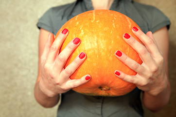 Image showing ripe pumpkin in hands of woman