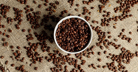 Image showing Bowl of coffee beans on canvas