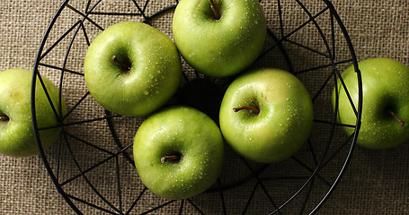 Image showing Green wet apples in vase