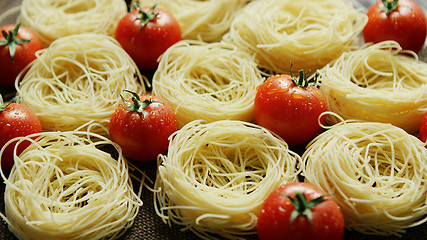 Image showing Spaghetti in rolls with fresh tomatoes