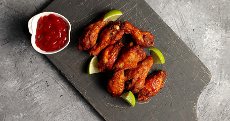 Image showing Delicious fried wings on board