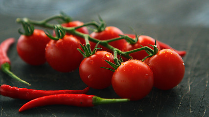 Image showing Fresh grapevine tomatoes and chili