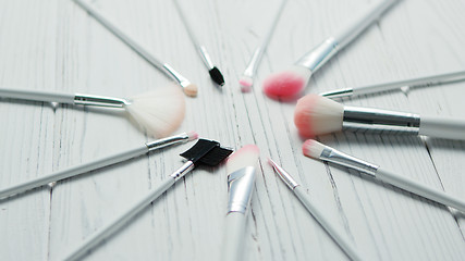Image showing Makeup brushed placed in circle