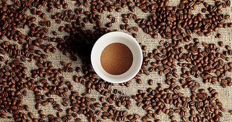 Image showing Coffee beans and cup of powder