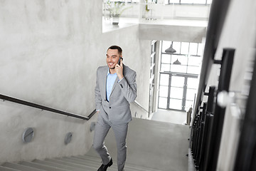 Image showing businessman calling on smartphone at office