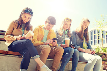 Image showing teenage friends with smartphone and coffee cups