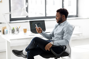 Image showing businessman with smartphone at office