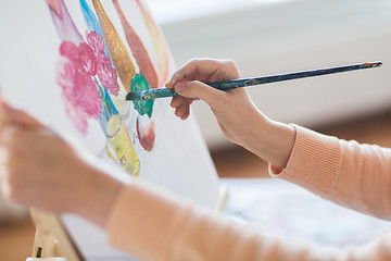 Image showing artist with brush painting still life at studio