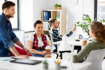 Image showing creative man with smartphone at office