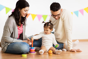 Image showing baby girl with parents playing with pyramid toy