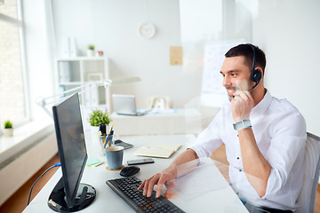 Image showing businessman with headset and computer at office