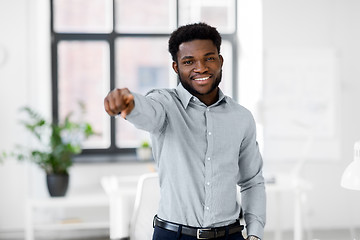 Image showing african businessman at office pointing at you