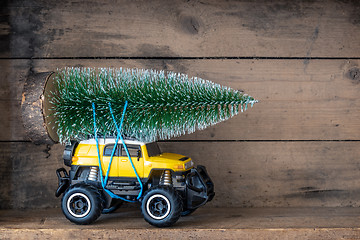 Image showing christmas tree on a yellow toy car
