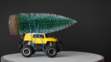 Image showing christmas tree on a yellow toy car