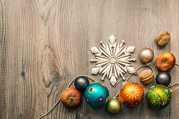 Image showing Christmas decoration glass balls on a wooden background