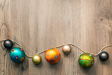 Image showing Christmas decoration glass balls on a wooden background