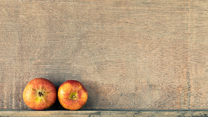 Image showing wooden background with two small apples