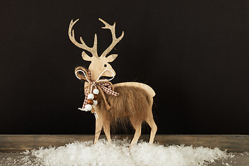 Image showing Christmas decoration wooden reindeer in snow