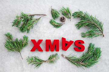 Image showing Pine branches and the word Xmas written upside-down