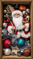 Image showing Santa Claus doll in a wooden box with Christmas decoration