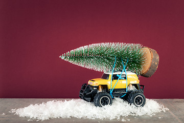 Image showing yellow SUV monster car truck toy with fir tree
