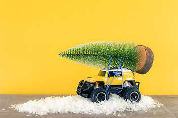 Image showing yellow SUV monster car truck toy with fir tree