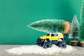 Image showing yellow SUV monster car truck toy with fir tree