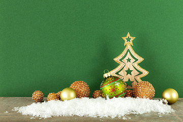 Image showing Christmas decoration green background with wooden tree glass bal