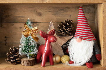 Image showing Christmas decoration deer figure and gnome in a wooden box backg