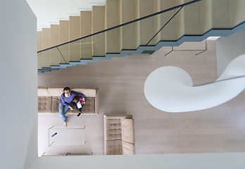 Image showing mother and her cute little daughter are using a tablet top view