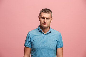 Image showing Suspiciont. Doubtful pensive man with thoughtful expression making choice against pink background