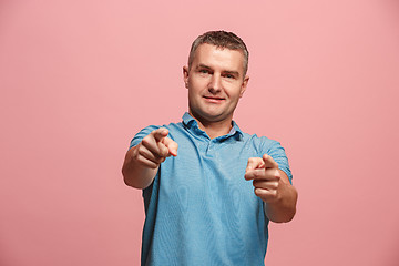 Image showing The happy business man point you and want you, half length closeup portrait on pink background.