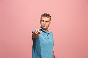 Image showing The serious business man point you and want you, half length closeup portrait on pink background.