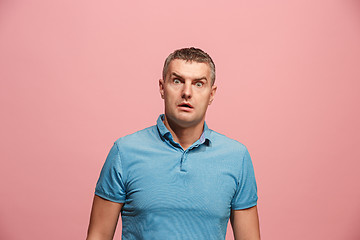 Image showing Portrait of the scared man on pink