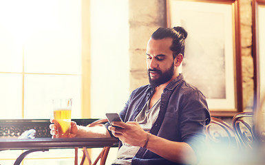 Image showing man with smartphone drinking beer at bar or pub