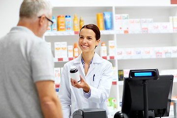 Image showing apothecary and senior customer at pharmacy