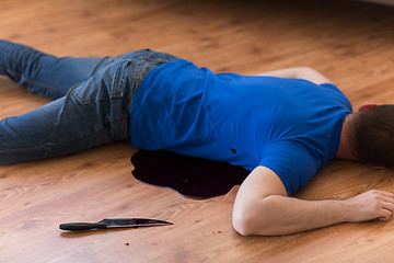 Image showing dead man body lying on floor at crime scene