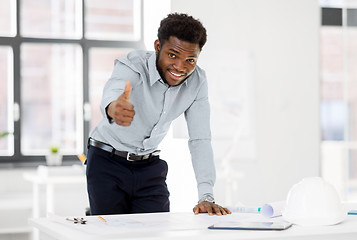 Image showing african architect with blueprint showing thumbs up