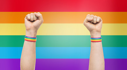 Image showing hands with gay pride rainbow wristbands shows fist