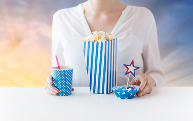 Image showing woman eating popcorn with drink in glass mason jar