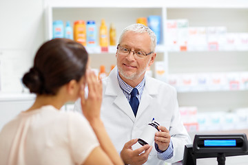 Image showing apothecary with cure and customer at pharmacy