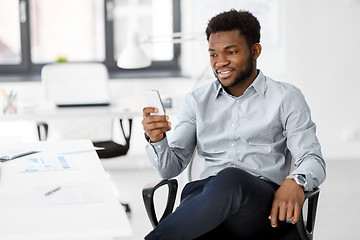 Image showing businessman with smartphone at office