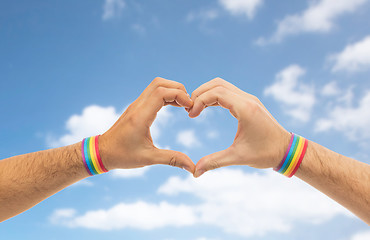 Image showing male hands with gay pride wristbands showing heart