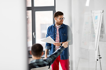 Image showing creative man showing user interface at office