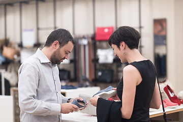 Image showing couple chooses shoes At Shoe Store