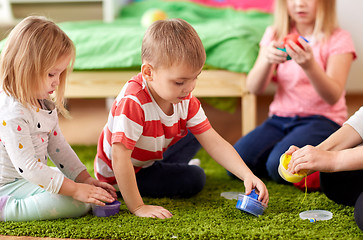 Image showing kids and mother with modelling clay or slimes