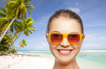 Image showing happy woman or teenage girl in sunglasses on beach