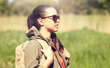 Image showing happy young woman with backpack hiking outdoors