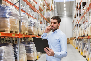 Image showing businessman calling on smartphone at warehouse