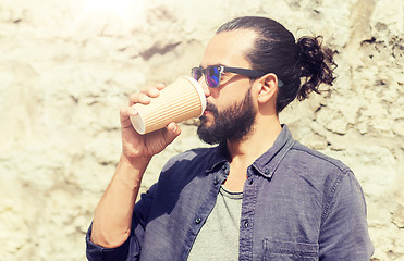 Image showing man drinking coffee from paper cup on street